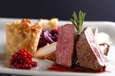 Venison meat steak with red cabbage clipart