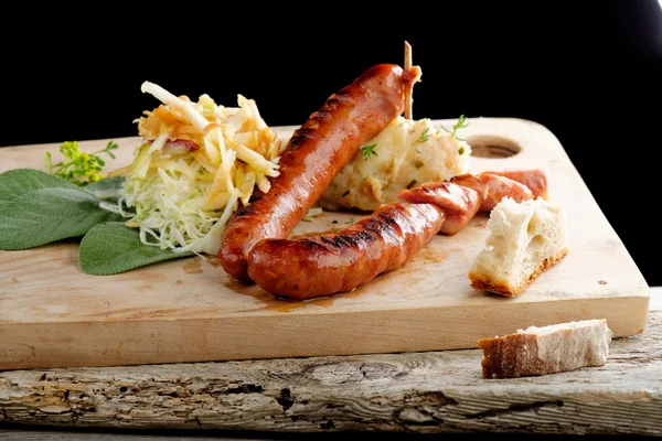 Grilled sausages with cabbage and mashed potato — Stock Photo, Image