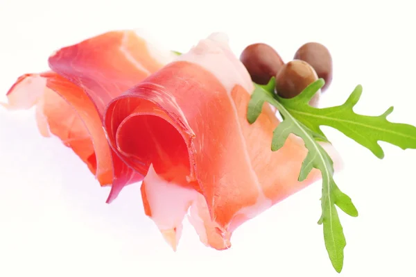 Sliced prosciutto on white background — Stock Photo, Image