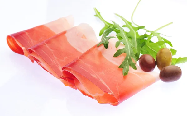 Sliced prosciutto on white background — Stock Photo, Image