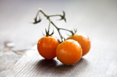 Kesme tahtasında bir dal kiraz domatesi.