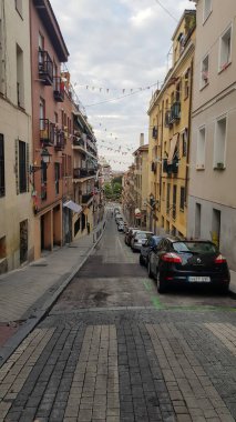 Madrid, İspanya - 20 Eylül - 2020: Arabaları, süslemeleri ve renkli binaları olan küçük cadde