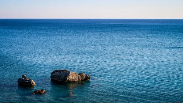 Rocks in the sea. Show of rocks. Calm blue sea