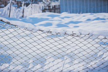 Fence covered in snow during winter