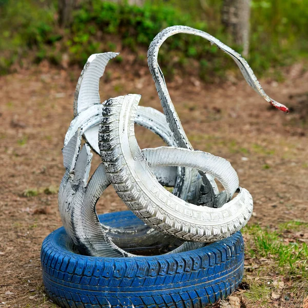 Children playground made of painted car tires in a forest near St. Petersburg — Stock Photo, Image