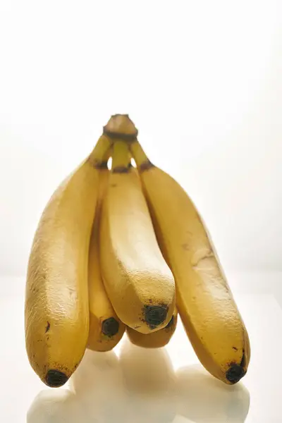 Bando de bananas amarelas maduras no fundo branco — Fotografia de Stock