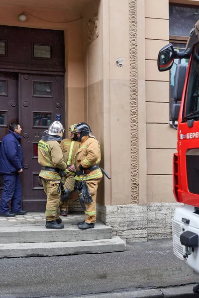 Bomberos de pie frente a una casa después de extinguir un incendio en Petersburgo — Foto de Stock