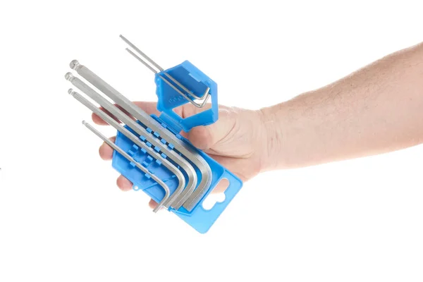 Hand holds a set of hex keys on a white background, a template for designers. —  Fotos de Stock