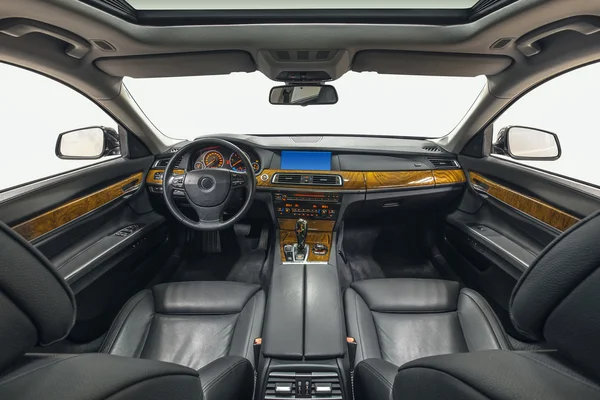 Interior of exclusive car. Black cockpit with wood decoration on isolated white background