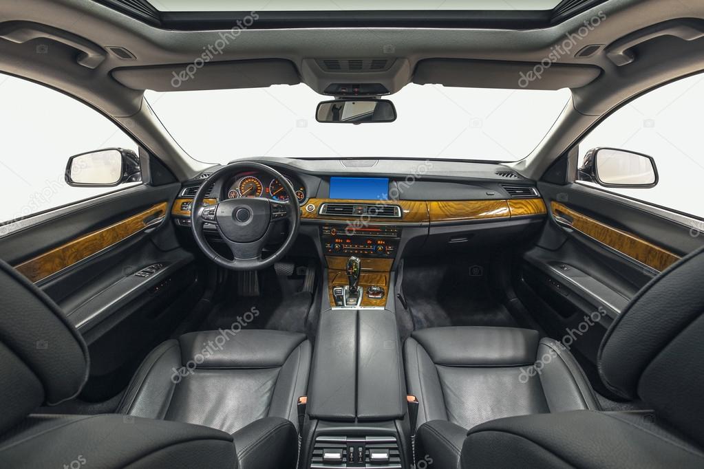 Interior of exclusive car. Black cockpit with wood decoration on isolated white background