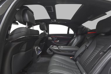 Interior of exclusive black car. Black seats with ambient red light isolated on white background