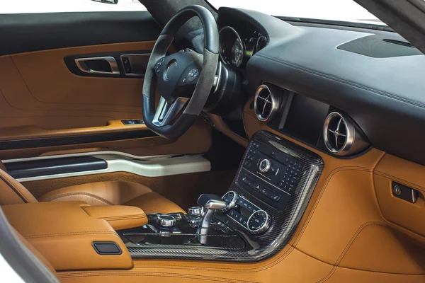 Interior of exclusive car. Orange cockpit with carbon decoration isolated on white background
