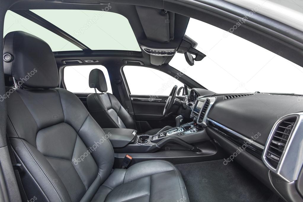 Black interior of exclusive car. Black cockpit with wood decoration