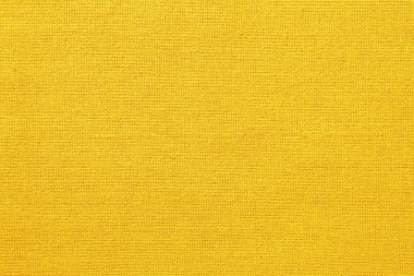 Sarı kumaş dokusu arka plan, doğal tekstil yüzeyinin pürüzsüz deseni.