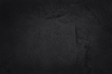 Koyu gri kayrak dokusu yüksek çözünürlüklü, arka planda siyah taş duvar var..
