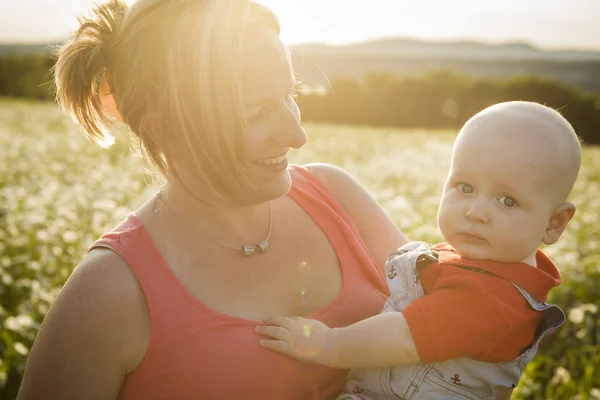 Happy joyful mother with baby son sunset — Stock Photo, Image