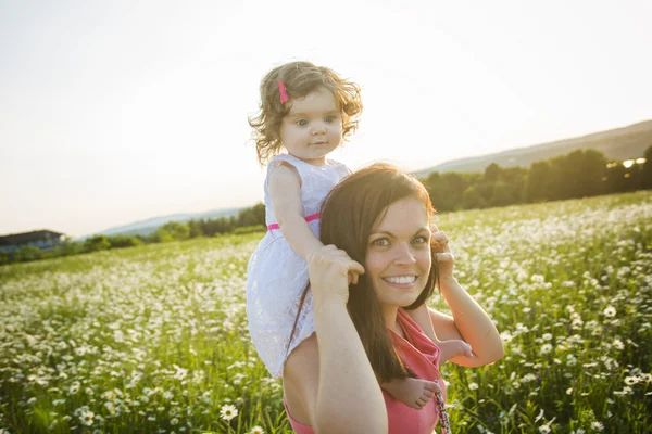 Happy joyful mother with daughter daisy field — Stock Photo, Image