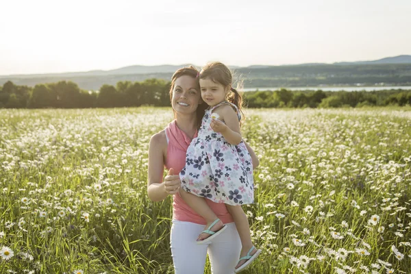 Happy joyful mother with daughter daisy field — Stock Photo, Image