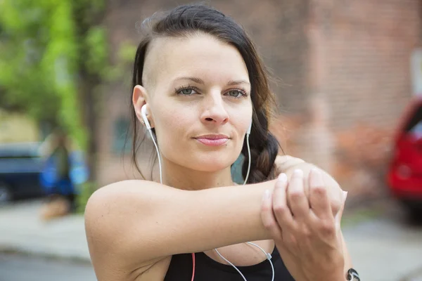 Young female runner in old city center — Stock Photo, Image