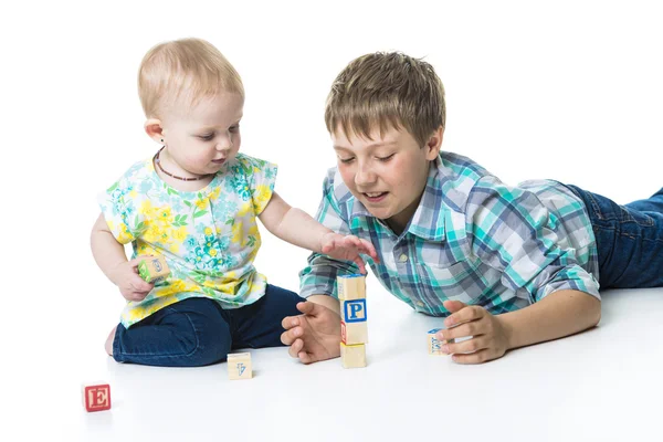 Brother and sister play laying on a floor — Stock Photo, Image