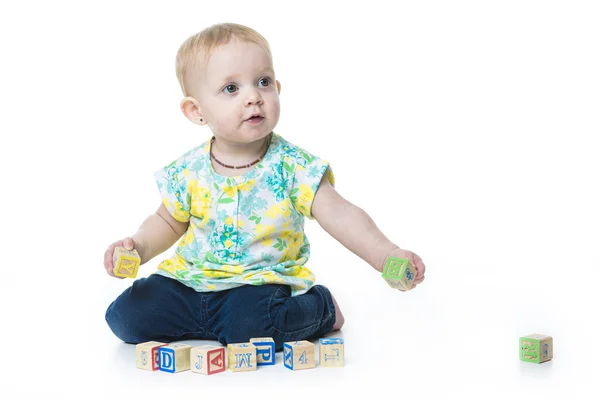 Happy kid playing toy blocks  isolated on white background — Zdjęcie stockowe