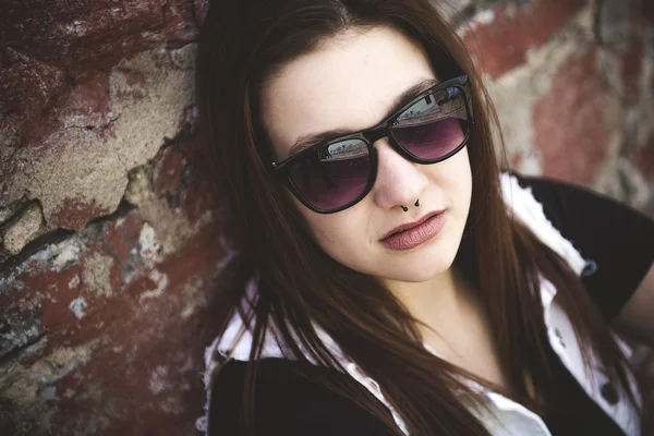 Retrato de jovem mulher bonita em fundo urbano — Fotografia de Stock