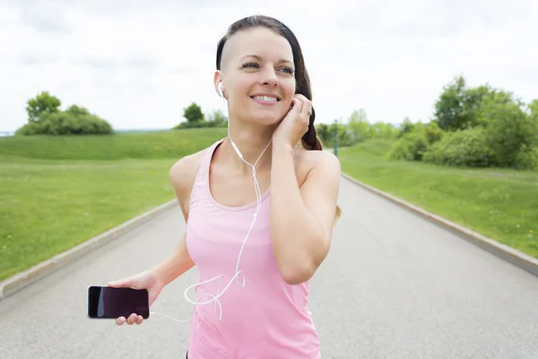 Sporty woman running outdoors in park — Stock Photo, Image