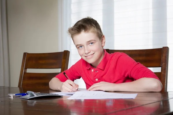 Boy doing his homework at home — Stok fotoğraf