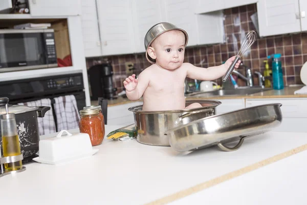 Adorable baby cooking in kitchen — Stock Photo, Image