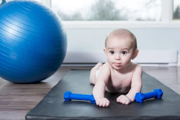 Cute baby doing exercises with ball at home — Stock Photo, Image