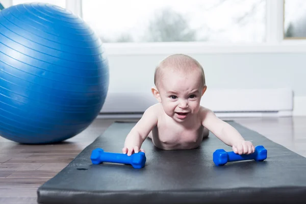 Cute baby doing exercises with ball at home — Stock Photo, Image