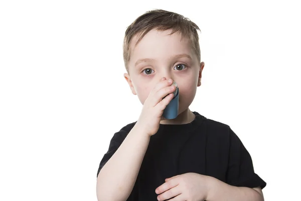 4 jaar oude jongen inhaleert zichzelf op een witte achtergrond — Stockfoto