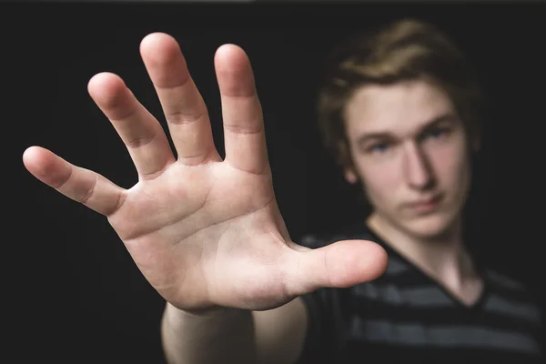 Image of a boy with his hand extended signaling to stop — Stock Photo, Image