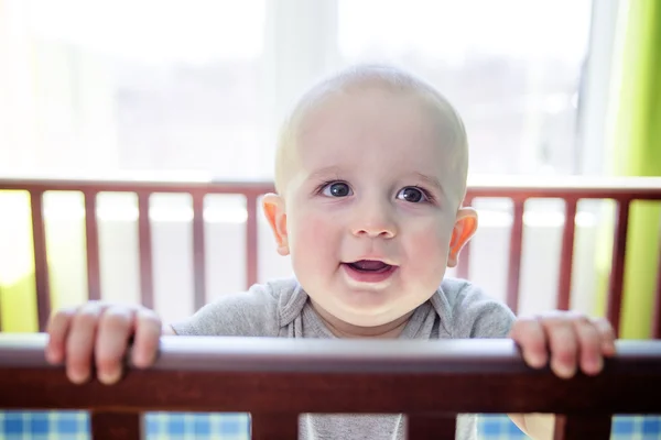 Adorable baby boy in his crib — Stock Photo, Image