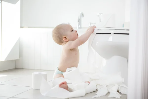 Adorable baby boy playing with toilet paper — Stock Photo, Image