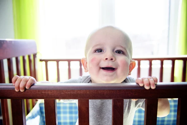 Adorable baby boy in his crib — Stock Photo, Image