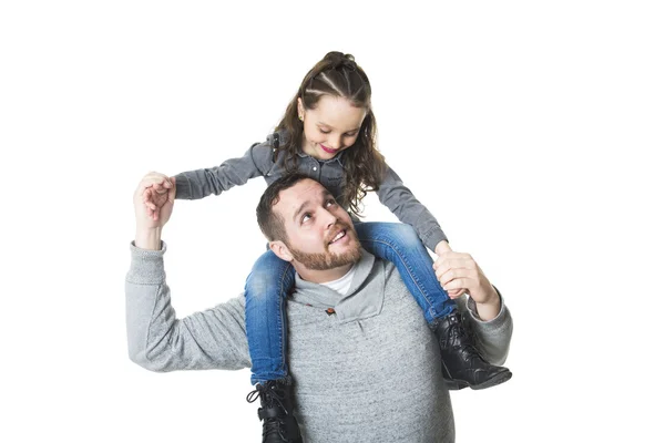 Father carrying daughter on his shoulders, studio shot — Stock Photo, Image