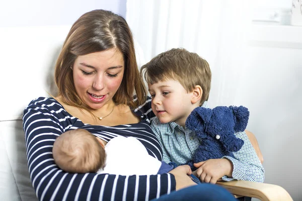 Young mother feeding her newborn child. — Stock Photo, Image