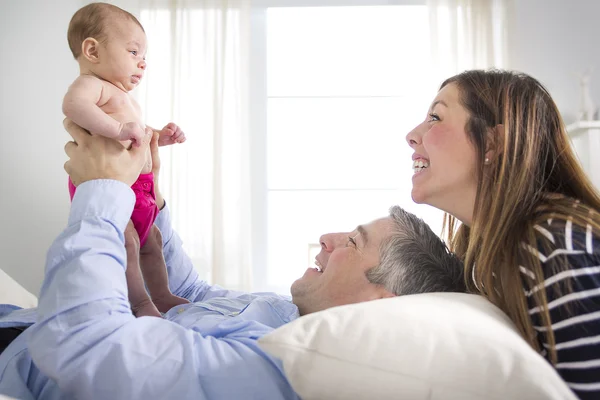 Parents Cuddling Newborn Baby In Bed At Home — Stock Photo, Image