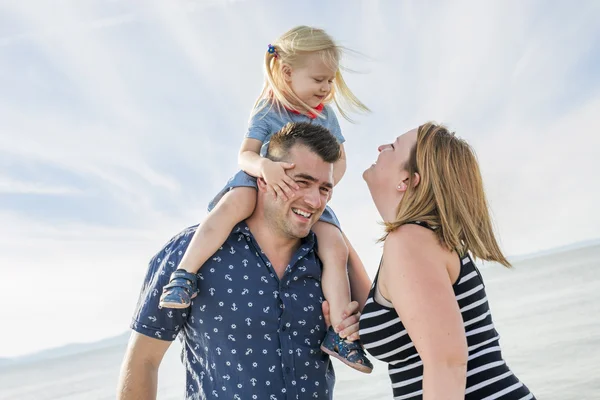 Family of three on beach having fun together — Stock Photo, Image