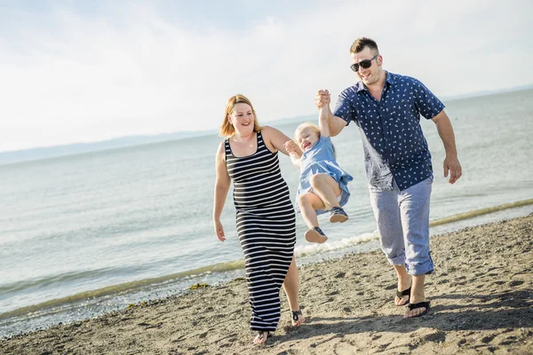 Family of three on beach having fun together — Stock Photo, Image