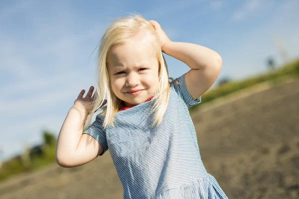 Cute little girl standing close to beach at sunset — Stock Photo, Image