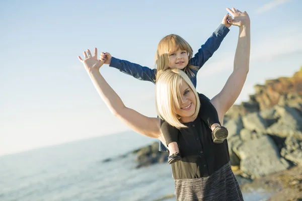 Mother and daughter on the beach side having fun — Stock Photo, Image