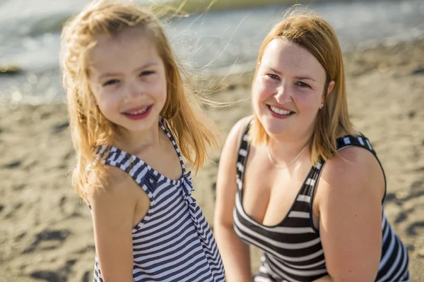 Mother and daughter on the beach side having fun — Stock Photo, Image