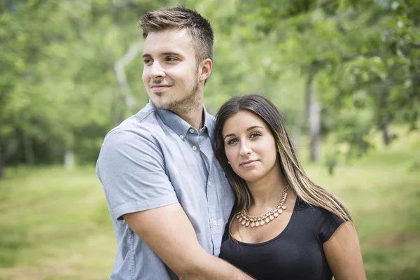 Happy loving young couple at the park — Stock Photo, Image