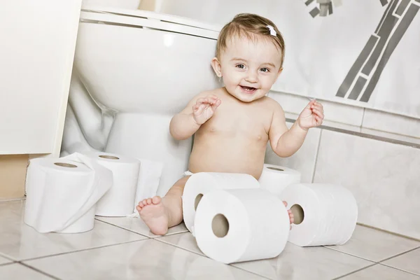 Toddler ripping up toilet paper in bathroom — Stock Photo, Image