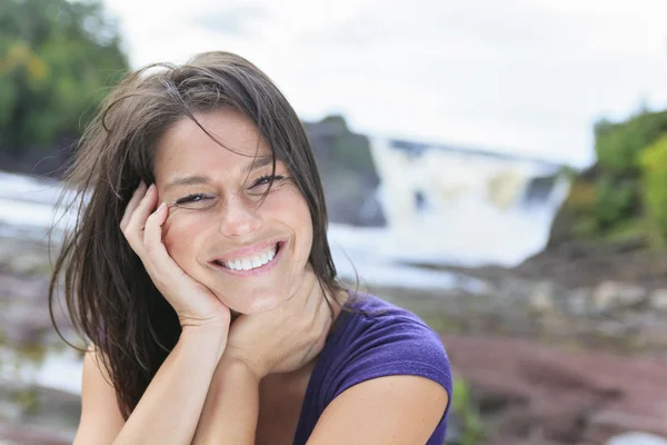 Woman portrait in nature with waterfall on the back — Stock Photo, Image