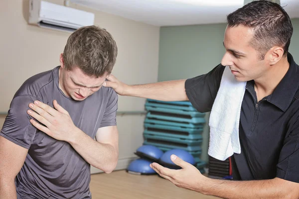 Portrait of a fitness man reaching for his knee in pain — Stock Photo, Image