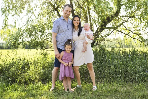 Happy and young family relaxing together in nature — Stock Photo, Image