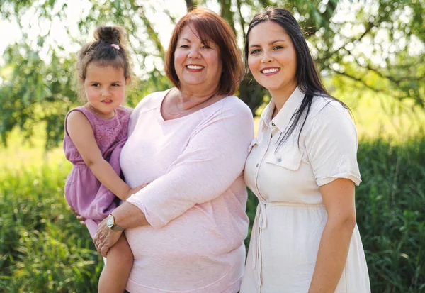 Grandmother spending time with littledaughter and girl during the day — Stock Photo, Image